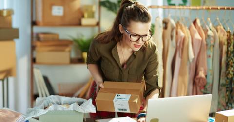stylish small business owner woman using laptop in office