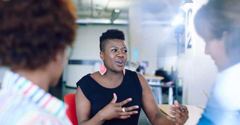 Unposed group of creative business people in an open concept office brainstorming their next project.