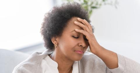 Black woman sitting on sofa at home have bad time