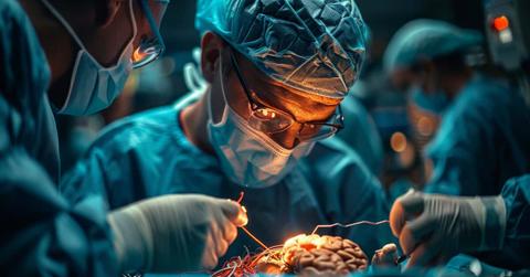 A neurosurgeon performs an operation. Robotic equipment in a modern neurosurgical clinic