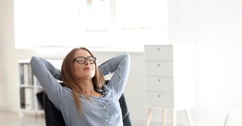 Young businesswoman relaxing at workplace in office