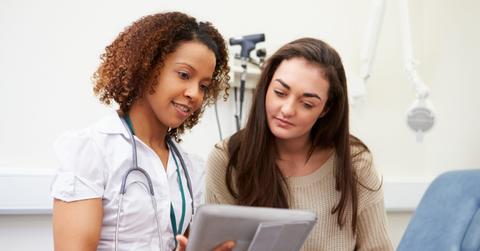 Nurse Showing Patient Test Results On Digital Tablet