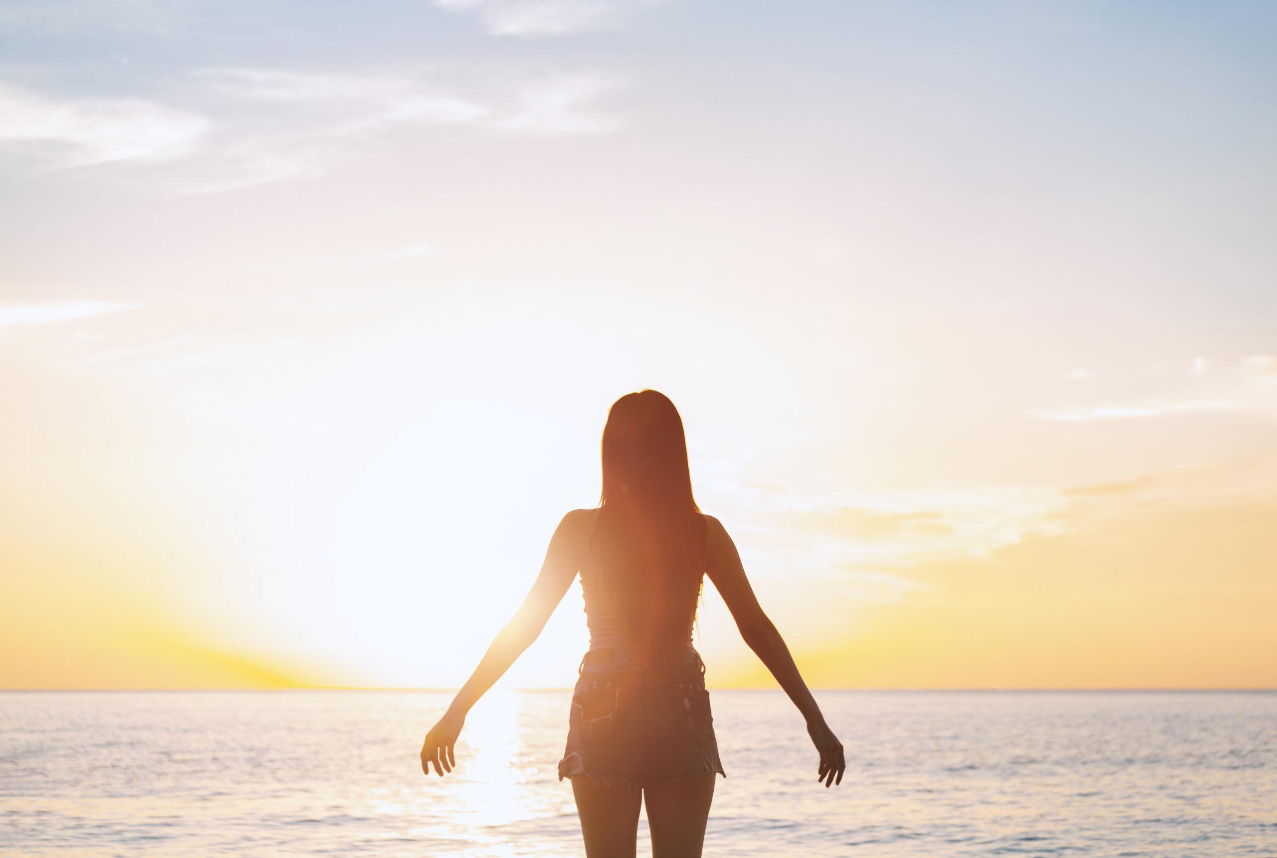 Silhouette sexy woman with hands on summer sunset beach. Christian praise on Easter good friday background. support nature standing open arms enjoying sun concept jesus fun world wisdom 2020