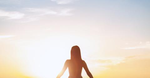 Silhouette sexy woman with hands on summer sunset beach. Christian praise on Easter good friday background. support nature standing open arms enjoying sun concept jesus fun world wisdom 2020