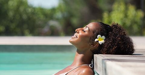 Beautiful african woman in pool relaxing
