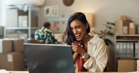 Woman, ecommerce and excited with laptop for sales negotiation, product investment or client growth. Indian, person and happiness for business meeting, profit celebration or logistics target at work