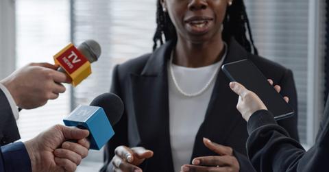 Black Female Official Giving Interview to Reporters Indoors