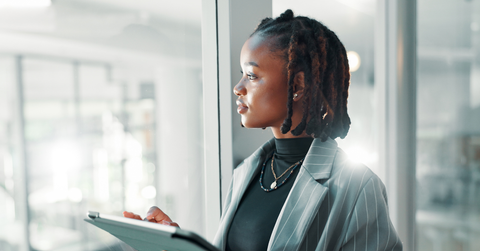 Woman in suit reflecting