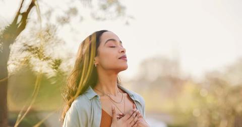 Mixed race woman relax and breathing fresh air outdoor at sunset
