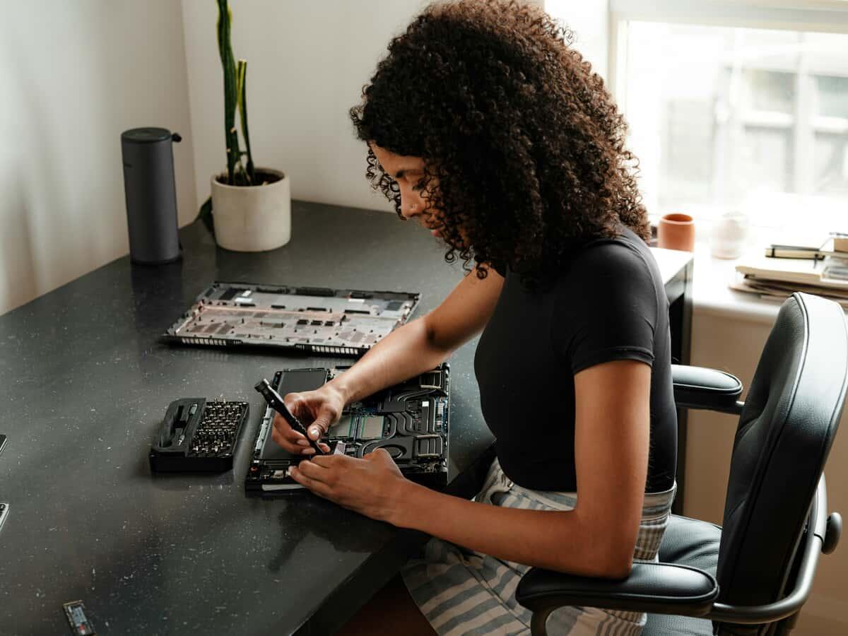 Woman fixing laptop