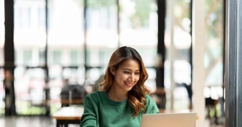 Asian woman working with laptop in her office. business financial concept.