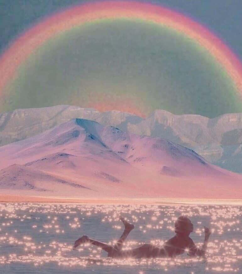 rainbow with female surfer on water