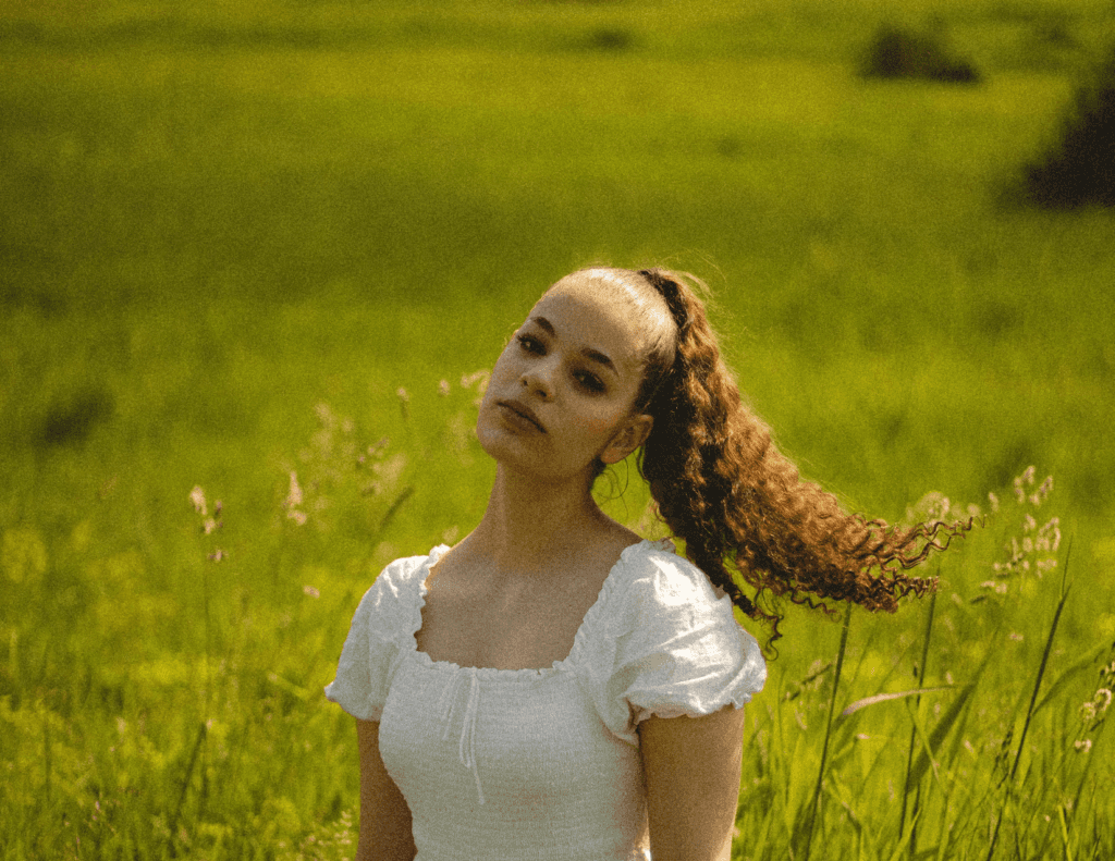 girl with ponytail in a meadow