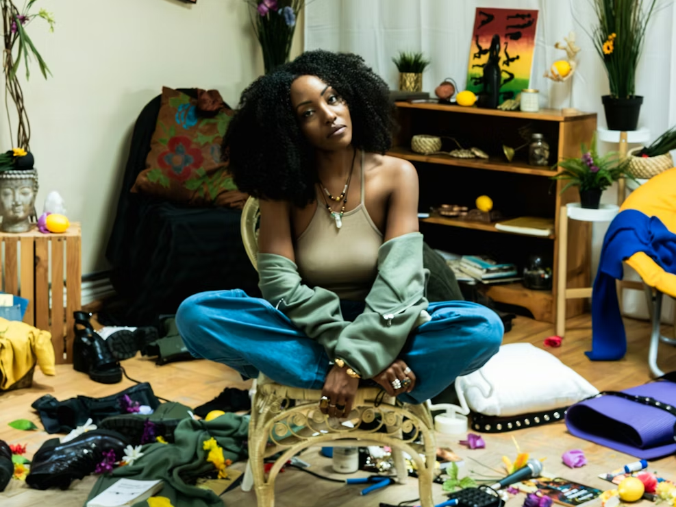 artist sits around her messy room