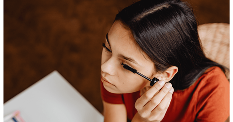 Woman putting on makeup