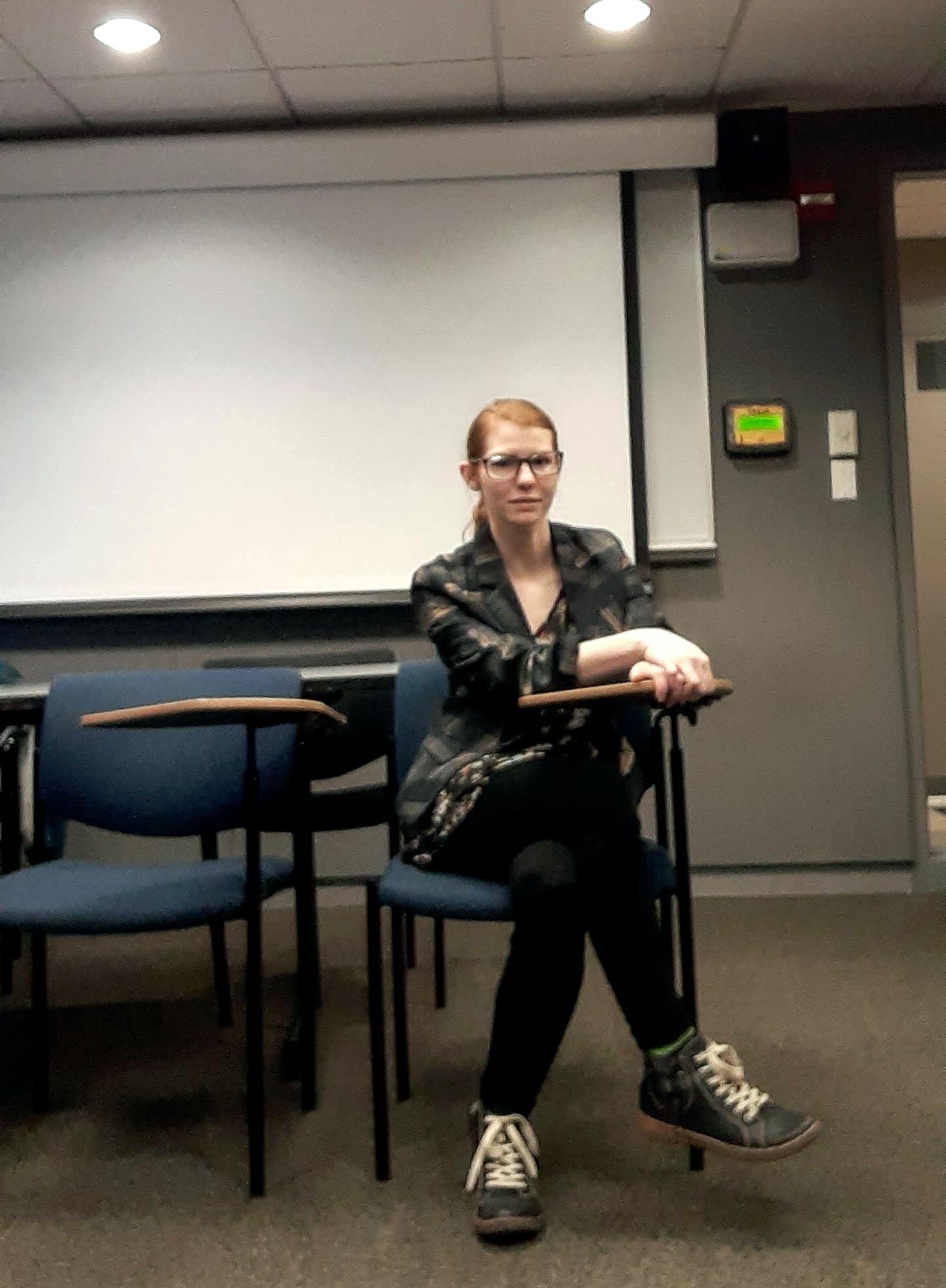 Brooke Knisley seated in her lecturing seat at Emerson College