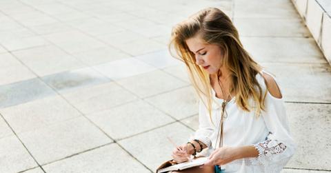Boho stylish chic woman writing outdoors free image
