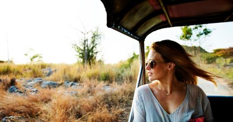 Young woman on the road trip to the nature